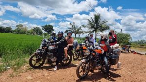 Easy Rider motorbike tour to Hoi An with riders beside rice fields