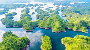 Green islands and blue water at Ta Dung Lake on the Da Lat Easy Rider 4-day loop
